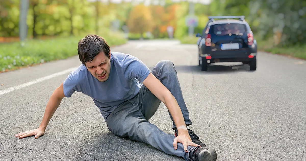 Hit and run concept. Injured man on road