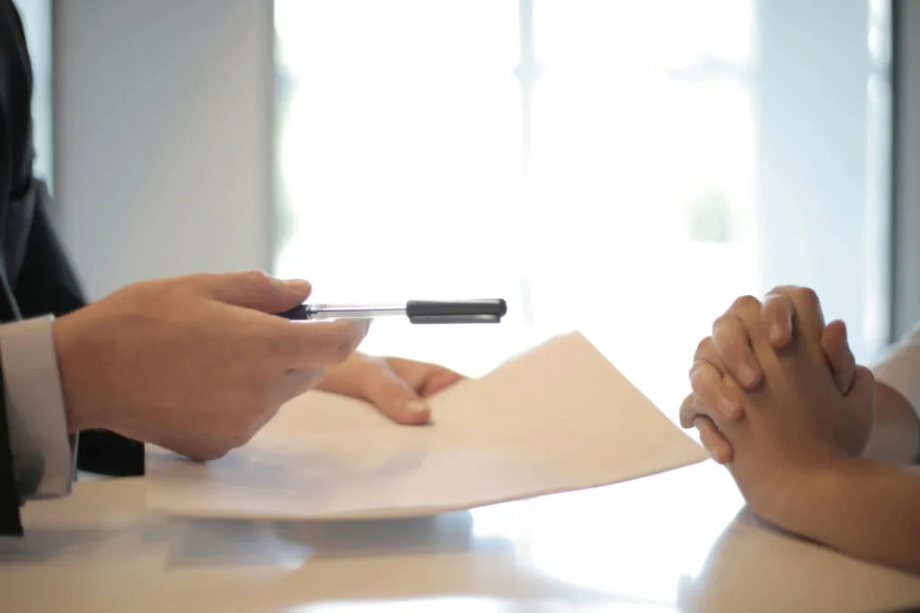 Businessman offering pen for agreement