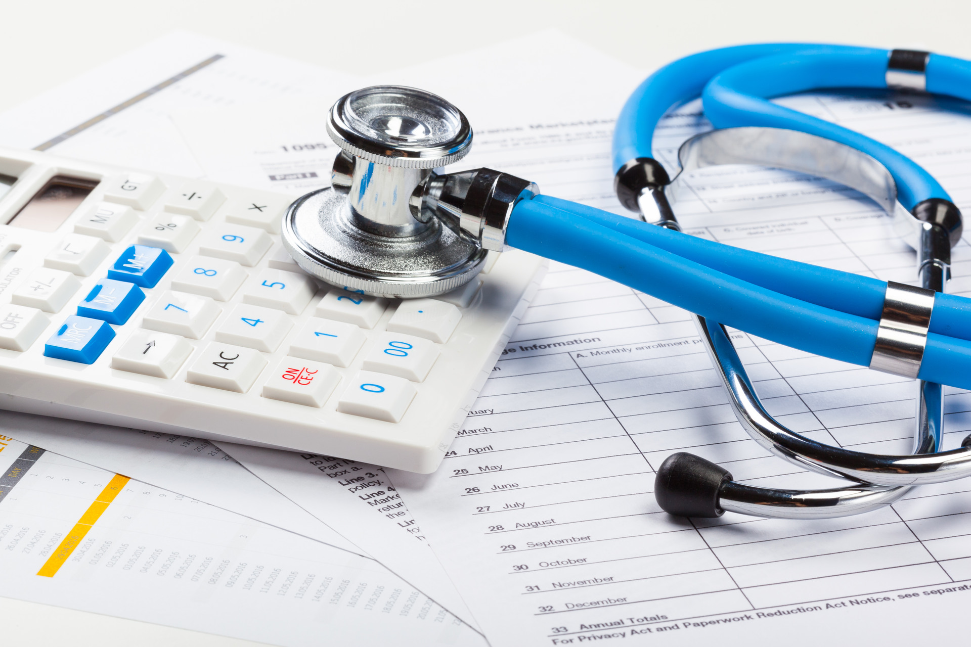 health care costs stethoscope and calculator