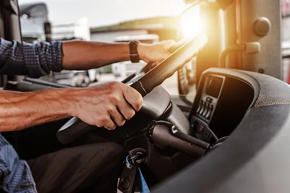 Truck driver hands on steering wheel